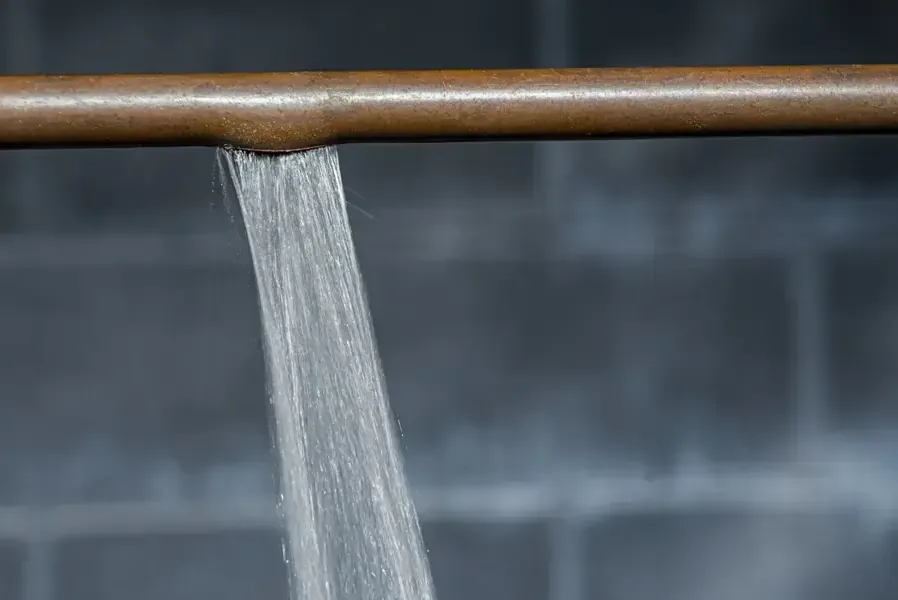 Water spraying out of a split supply pipe